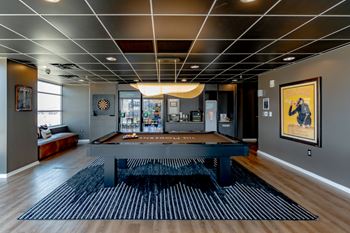 Resident lounge with billards, cozy seating, and darts