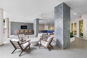 Boyton Beach apartment for rent - A living room with a white couch and a blue chair.