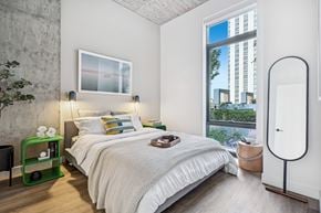 Chicago apartment for rent - a bedroom with a bed and a large window
