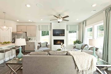 Mauldin apartment for rent - A modern living room with a grey couch and a fireplace.