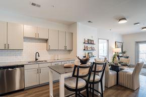 Charlotte apartment for rent - A modern kitchen with a dining table and chairs.