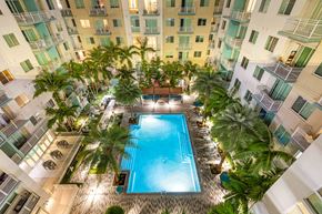 Ft Lauderdale apartment for rent - an overhead view of an apartment building with a pool and palm trees
