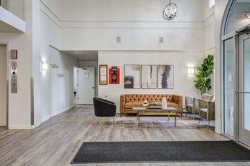 St. Louis Park apartment for rent - A living room with a brown couch and a black chair.