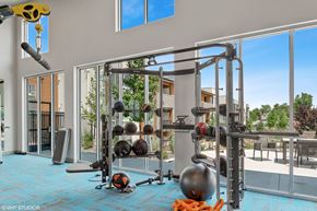 Aurora apartment for rent - A gym with a blue floor and a variety of equipment.