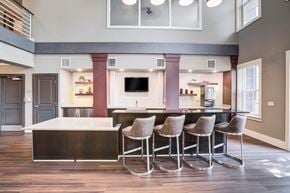 Orlando apartment for rent - a kitchen with a large center island with a breakfast bar and a living room in the background