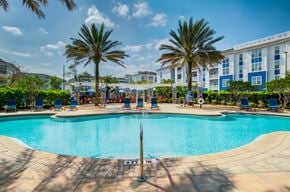 Orlando apartment for rent - a swimming pool with a fountain in front of a building