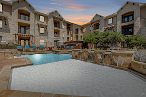 Grand Prairie apartment for rent - A large swimming pool in front of apartment buildings.