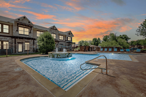 Grand Prairie apartment for rent - A swimming pool in front of a house with a fountain.