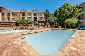 Grand Prairie apartment for rent - A large swimming pool in front of apartment buildings.