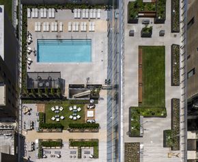 Chicago apartment for rent - A large outdoor swimming pool surrounded by a glass fence.