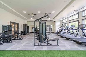 Canton apartment for rent - A spacious gym with a variety of equipment including treadmills, elliptical machines, and weight machines.