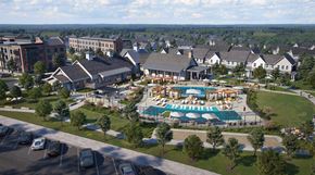 Zionsville apartment for rent - A large building complex with a pool in the middle.