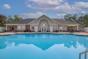 Spartanburg apartment for rent - A large swimming pool in front of a house.