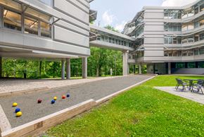 Danbury apartment for rent - a large building with a yard with balls on the ground