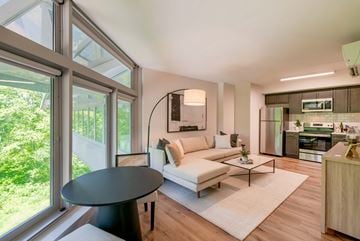 Danbury apartment for rent - A modern living room with a black table and a white sofa.