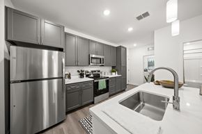 Nokomis apartment for rent - A modern kitchen with a stainless steel refrigerator and a quartz countertop.