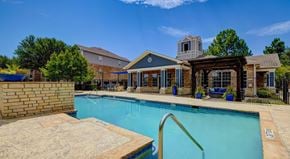 Grand Prairie apartment for rent - A large swimming pool in front of a house.