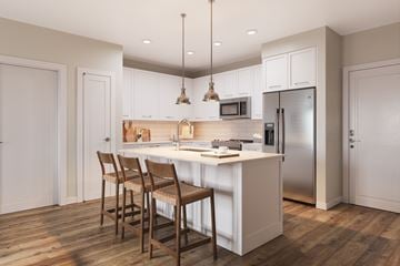 Kissimmee apartment for rent - A kitchen with a white countertop and wooden chairs.