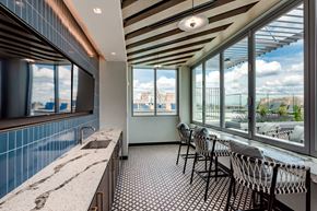 Arlington apartment for rent - a bar with tables and chairs and a window with a view