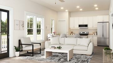 Gastonia townhouse for rent - A modern living room with white furniture and a kitchen in the background.