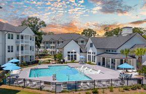 Summerville apartment for rent - A large white building with a pool in front of it.