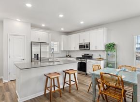 Myrtle Beach apartment for rent - A kitchen with white cabinets and a black stove.