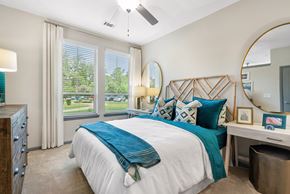 Summerville apartment for rent - A bedroom with a large bed and a ceiling fan.