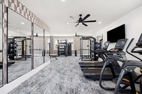 Myrtle Beach apartment for rent - A gym with treadmills and a fan.