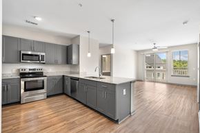 Summerville apartment for rent - A modern kitchen with wooden floors and stainless steel appliances.