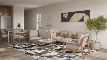 Spring Hill apartment for rent - A modern living room with a large sofa, a coffee table, and a painting on the wall.