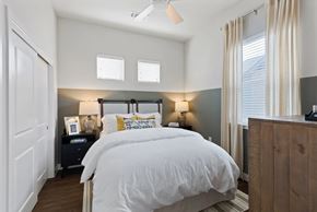 Celina apartment for rent - A bedroom with a large bed and a wooden headboard.