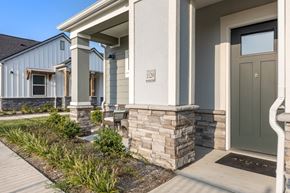 Justin apartment for rent - A house numbered with a color door and a stone pillar.