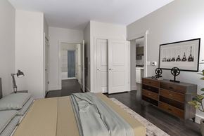 Belleville apartment for rent - A bedroom with a bed, dresser, and mirror.