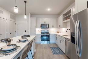 Spring Hill apartment for rent - A modern kitchen with a dining table set for two.