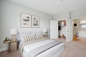 Canton apartment for rent - A bedroom with a large bed and two lamps.
