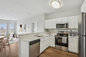 Canton apartment for rent - A modern kitchen with white cabinets and stainless steel appliances.