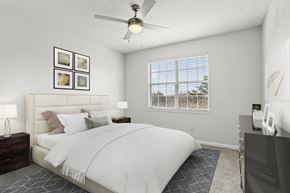 Atlanta apartment for rent - a bedroom with a white bed and a ceiling fan