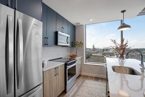 Nashville apartment for rent - A modern kitchen with a stainless steel refrigerator and a view of the city.