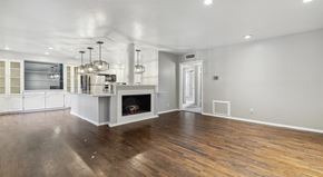 Dallas apartment for rent - an empty living room with a fireplace and a kitchen