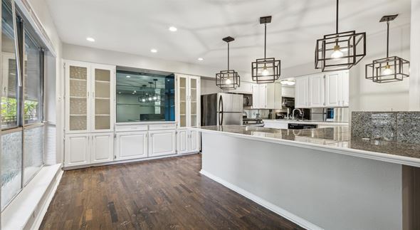 Dallas apartment for rent - a kitchen with white cabinets and a counter top