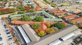 Dallas apartment for rent - an aerial view of a building surrounded by trees and a parking lot