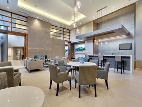 Dallas apartment for rent - a large living room with tables and chairs and a fireplace