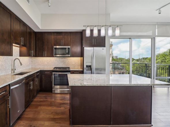 Dallas apartment for rent - a kitchen with a large island and a balcony