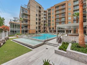 Dallas apartment for rent - a swimming pool in front of an apartment building