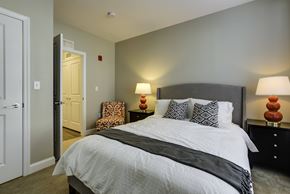 Chelmsford apartment for rent - A bedroom with a large bed and two lamps.