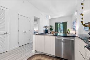 Davie apartment for rent - a kitchen with an island and a door to a hallway