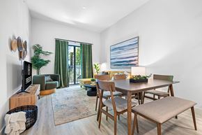 Davie apartment for rent - a living room with a dining room table and chairs and a tv
