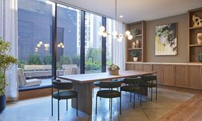Chicago apartment for rent - a dining room with large windows and a table and chairs