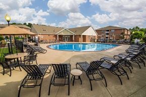 Wilmington apartment for rent - A pool surrounded by chairs and tables.