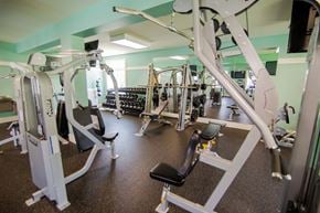Wilmington apartment for rent - A gym with a variety of equipment including treadmills, weights, and exercise machines.
